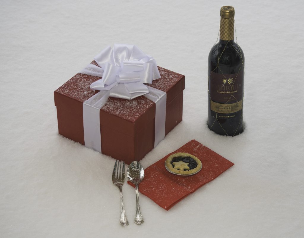 Presents, wine and mince pie on snow