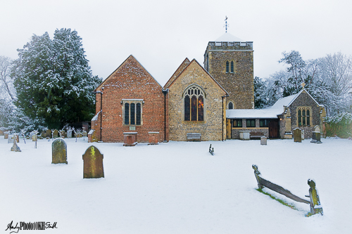 snowy scene of churchyard