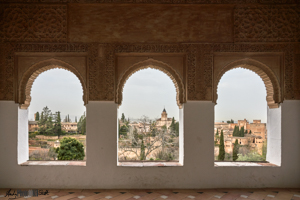 Three windows looking onto the town