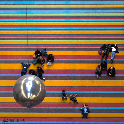 Giant silver bowling ball above reclining art fans