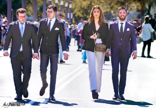 Four Spanish people walking on a road