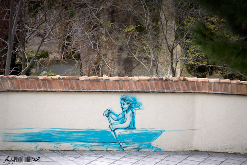 Blue boy paddling a boat