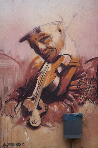 Graffito man playing violin
