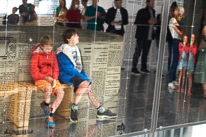 Reflected tedium two boys queuing waiting