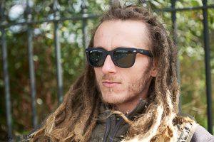 White guy with shades and deadlocks profile