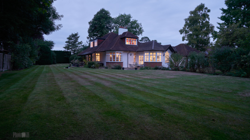 Chalet bungalow set in big garden early evening.