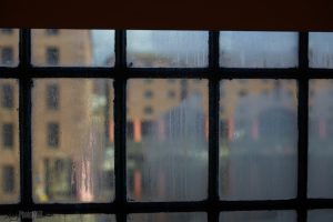 Yellow buildings of Liverpool docks viewed from the fogged window of the Tate