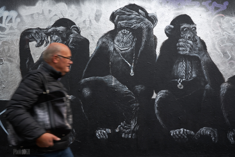 Man walks in front of Monkey Street Art