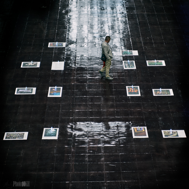 A few prints on the floor being viewed by a single person