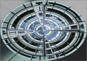 Radial image of an office near the Barbican with clouds reflected in the glass of the higher stories