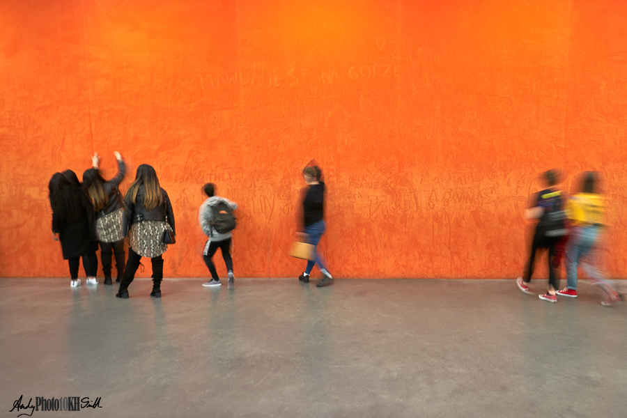 Young people interacting with the tactile orange wall