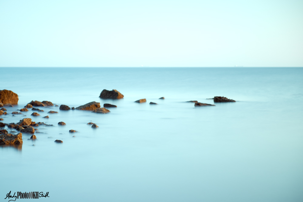 Slow sutter speed image of rocks off Benllech beach Anglesey Wales