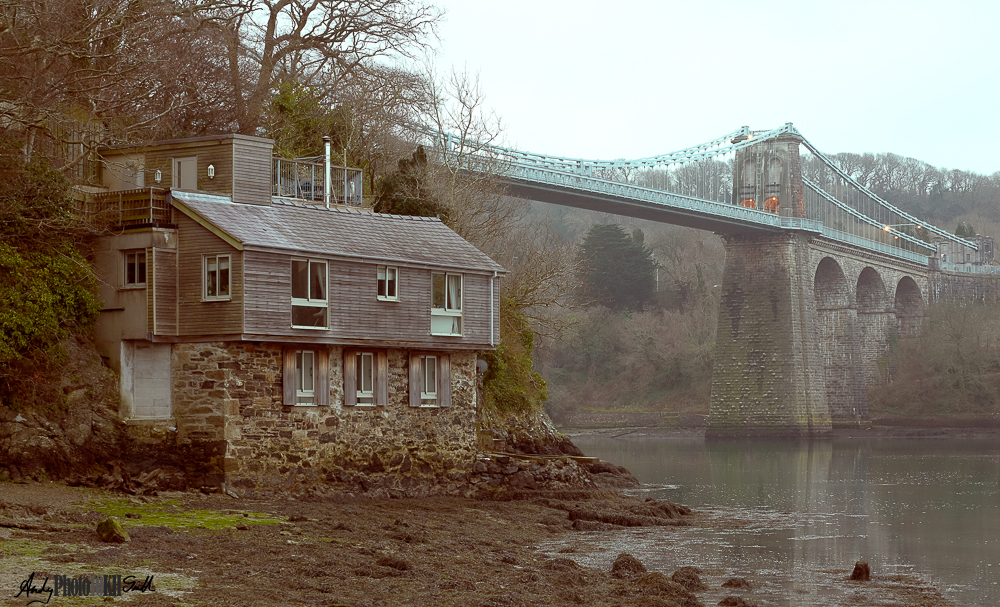 View of waterside house and the Telford's Suspension Bridge over the Menai Strait