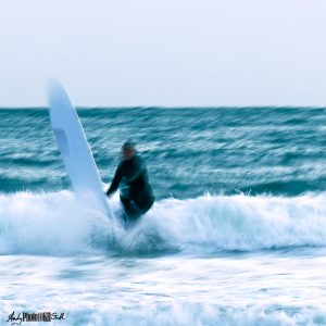 Surfer finishing their ride