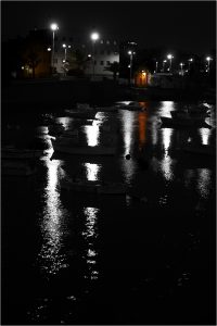 Low key image boats in marina after nightfall