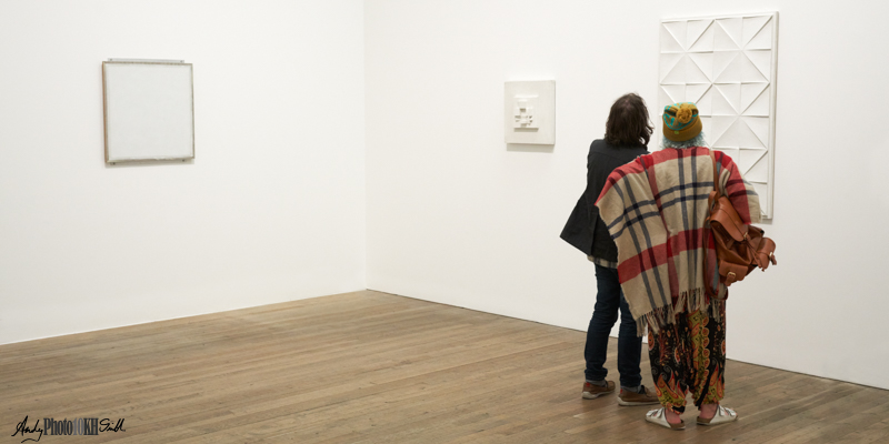 Women looking at pure white paintings