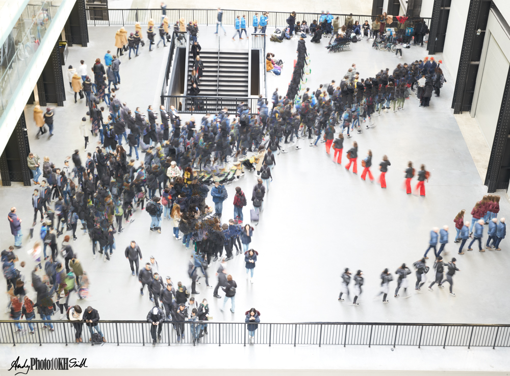 Multi-exposure composite showing movement of people across the hall