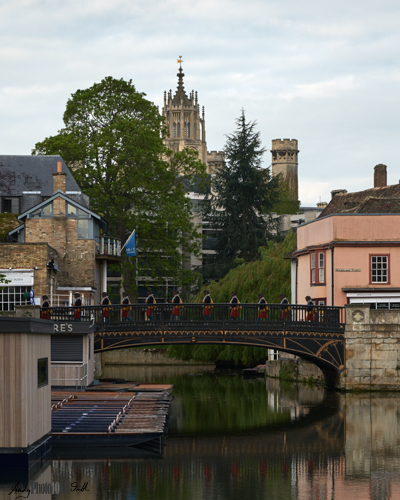 Multiple exposure of woman walking across the bridge on Magdelene street near the college