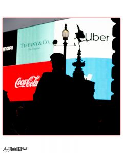 Silhouetted Figure against large illuminated billboards