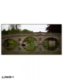 Punt passing under a bridge in Cambridge