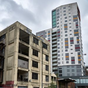 Derelict building beside its renovated counterpart