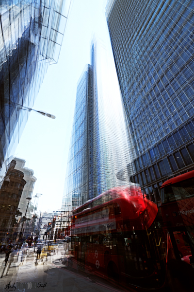 Tall shiny city buildings and London bus