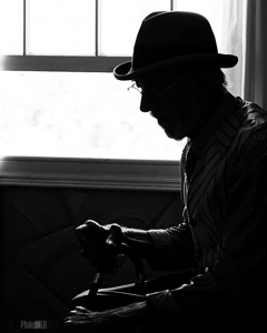 Monochrome old man by window