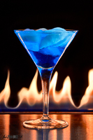 Blue cocktail contrasting in orange flames