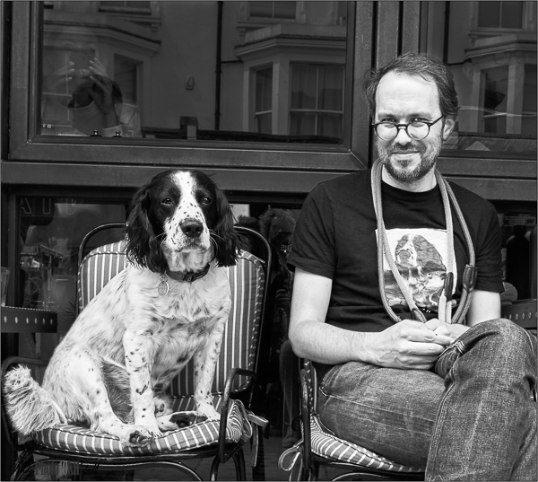 Man with dog and t-shirt bearing picture of same dog
