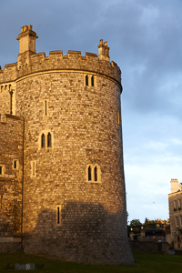 Castle tower looking golden against blue sky