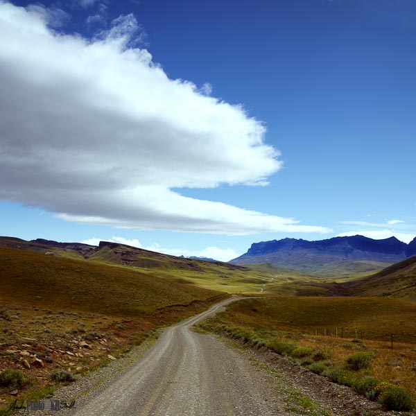 Cloud mirroring road to mountains