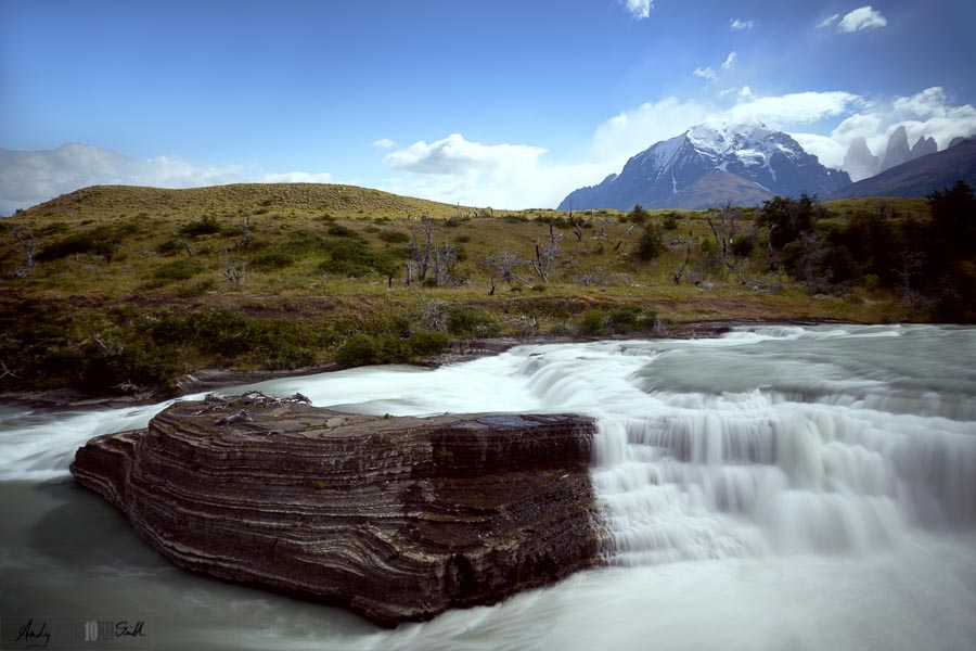 Big rock in waterfall Torres del Paine in the background