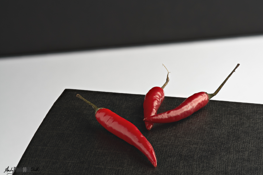 Minimalist Still Life featuring chillis on an angular mono background